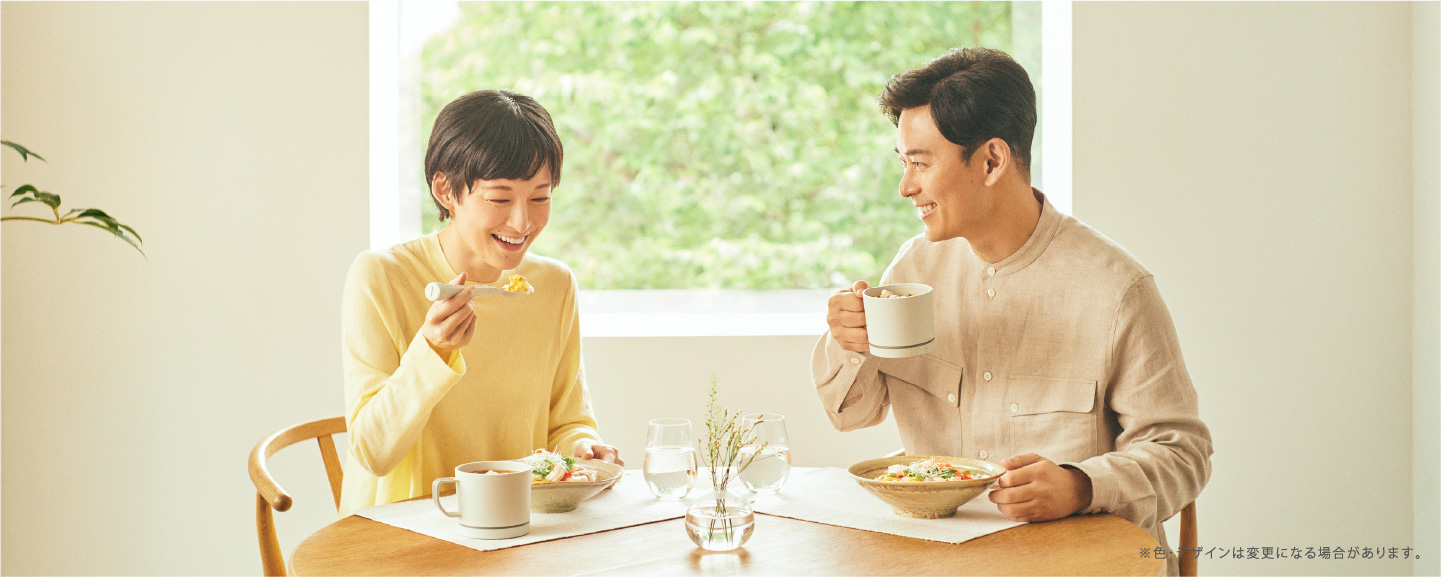 A couple enjoying a meal with the Electric Salt Spoon and Cup.