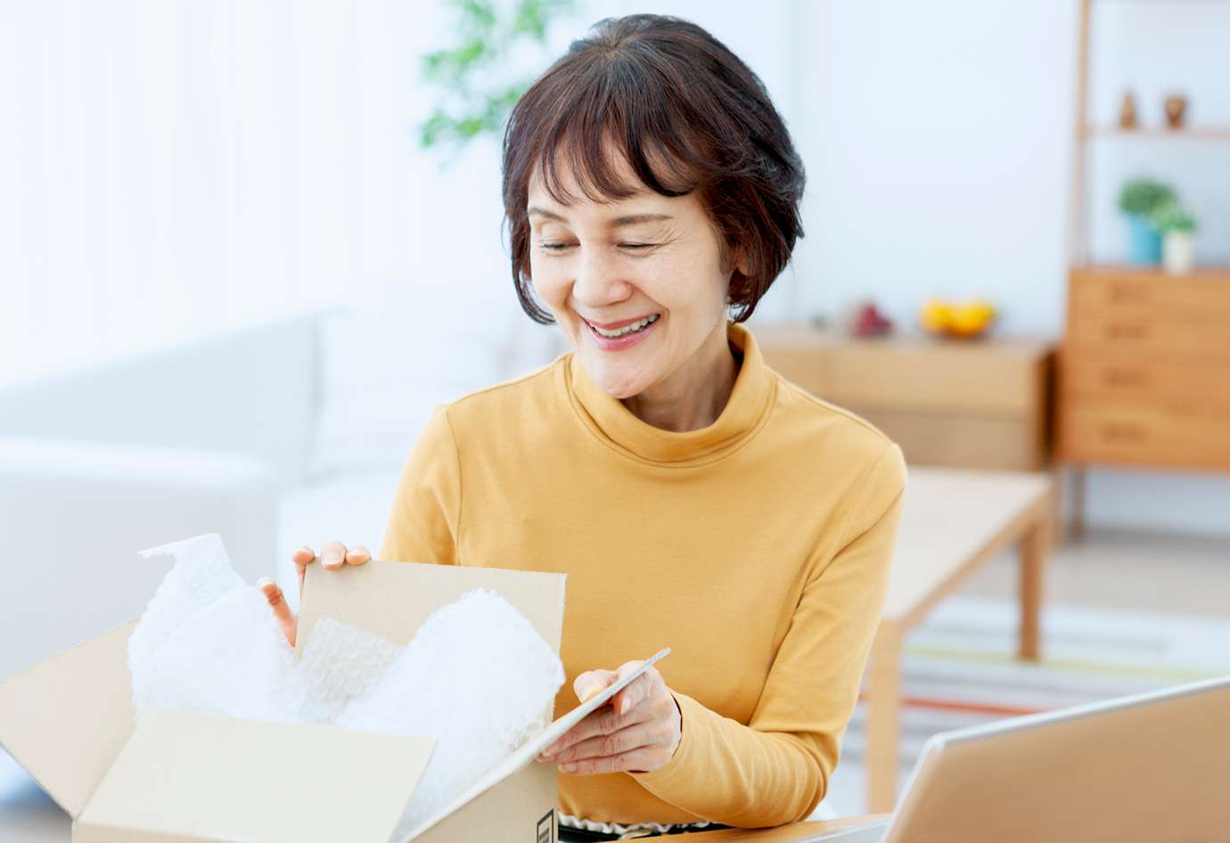 届いた商品を開封する両親のイメージ